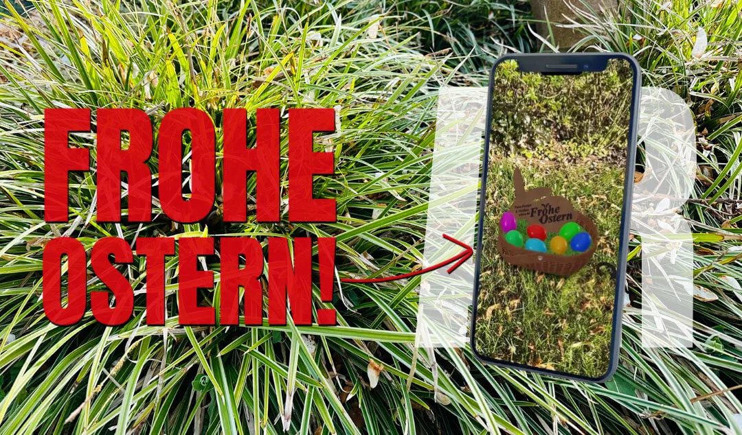 Smartphone zeigt einen Osterkorb mit bunten Eiern in Augmented Reality auf einer Wiese, daneben der Schriftzug „Frohe Ostern“